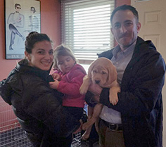 family with their new puppies