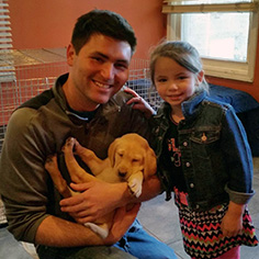 father and daughter with new puppy